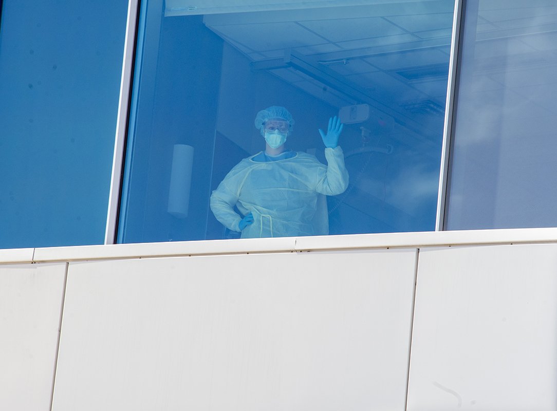 Nurse waving from hospital window