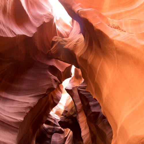 Looking up at a red rock formation with deep orange and red colors
