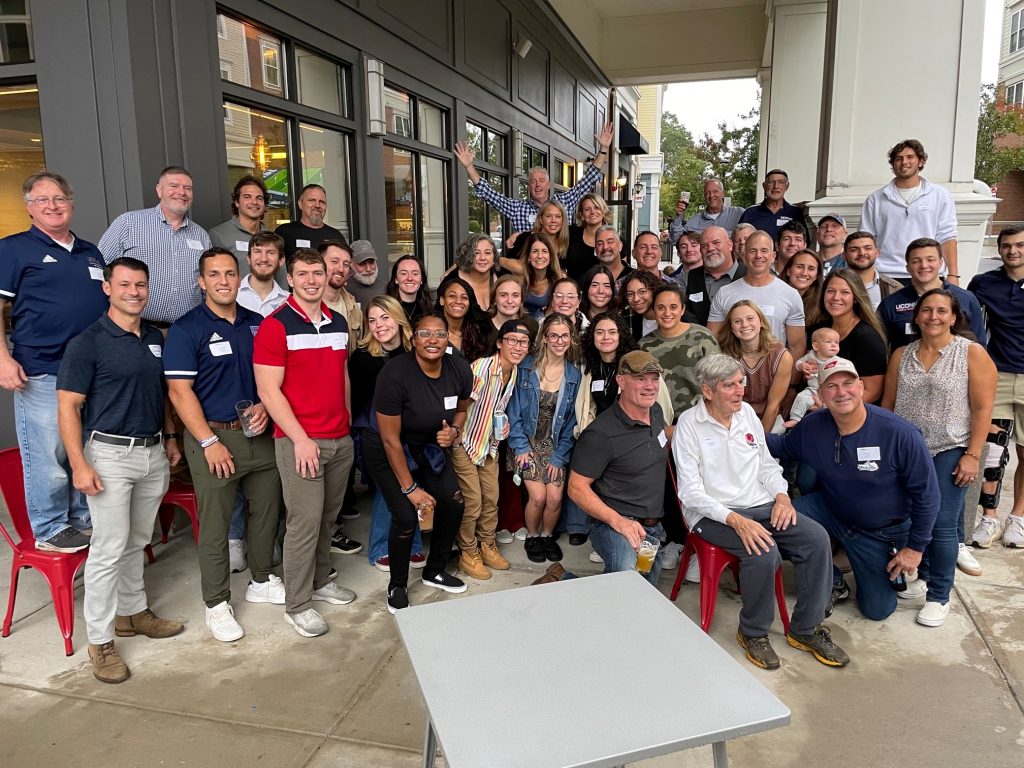 Group photo of a UConn alumni group standing and smiling.